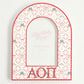Decorative arch-shaped frame with Alpha Omicron Pi Greek letters and decorative pattern on a white background