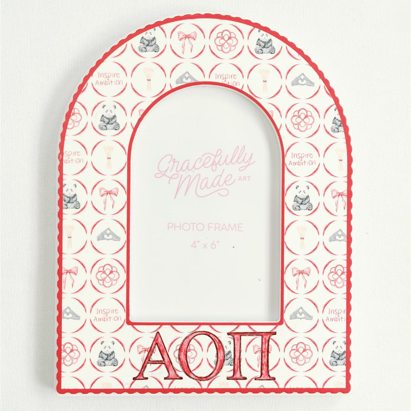 Decorative arch-shaped frame with Alpha Omicron Pi Greek letters and decorative pattern on a white background