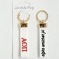 Front and back of the white Alpha Omicron Pi embroidered keychain.