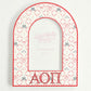 Decorative arch-shaped frame with Alpha Omicron Pi Greek letters and decorative patterns on a white background