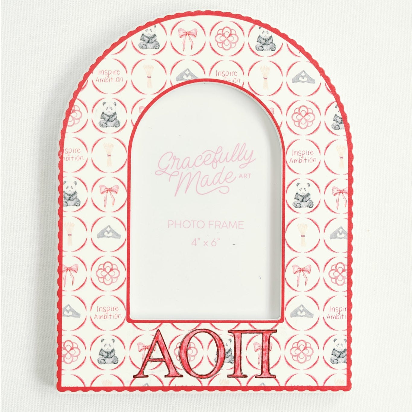 Decorative arch-shaped frame with Alpha Omicron Pi Greek letters and decorative patterns on a white background