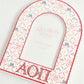 Decorative arched picture frame with Alpha Omicron Pi initials on a white background