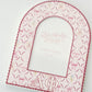 Arch-shaped photo frame with Alpha Phi decorative patterns and Greek letters on a white background.