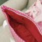 Close-up of a pink checkered bag with red interior liner.