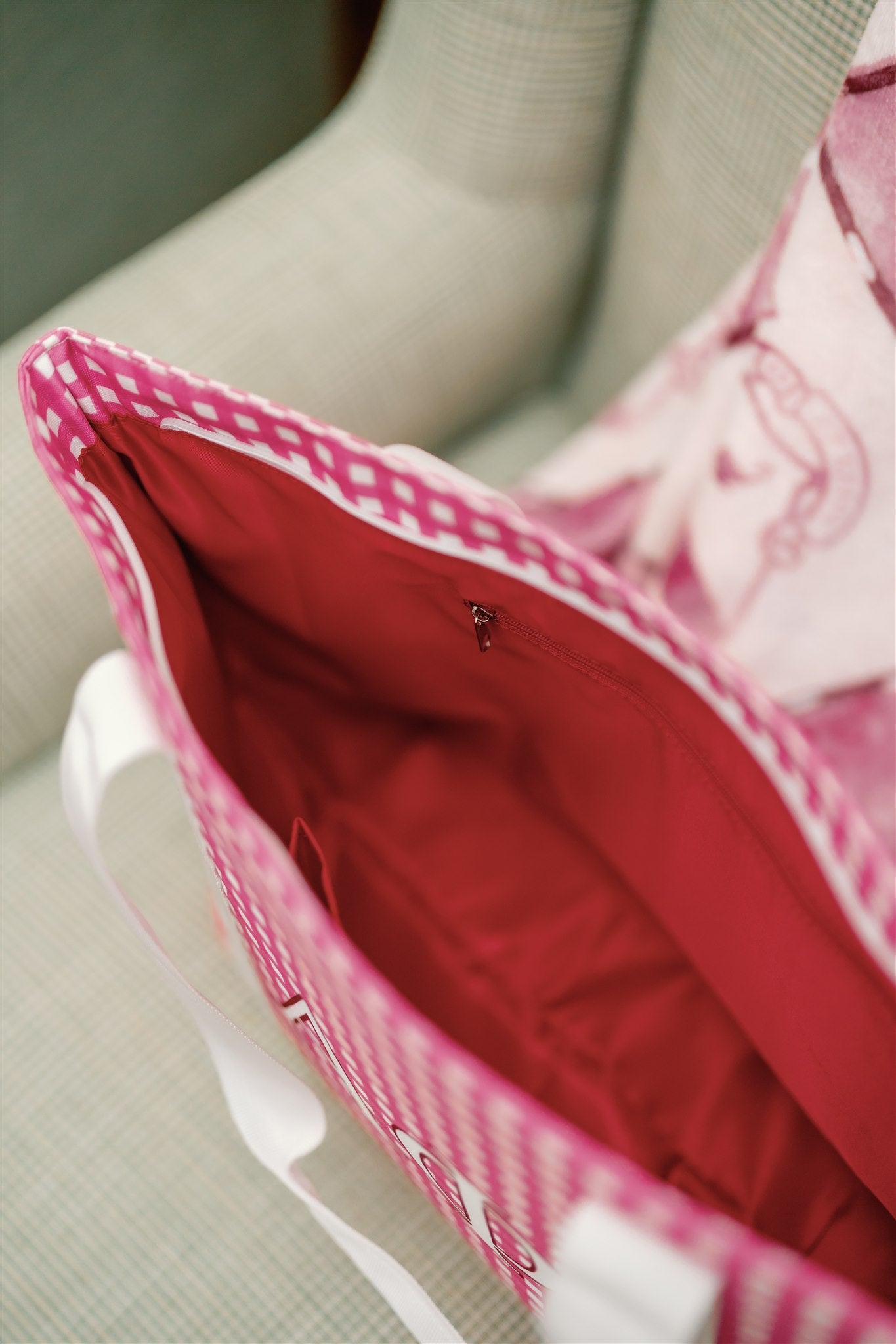 Close-up of a pink checkered bag with red interior liner.