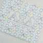 Art print with Alpha Xi Delta Greek letters and pattern on a white background