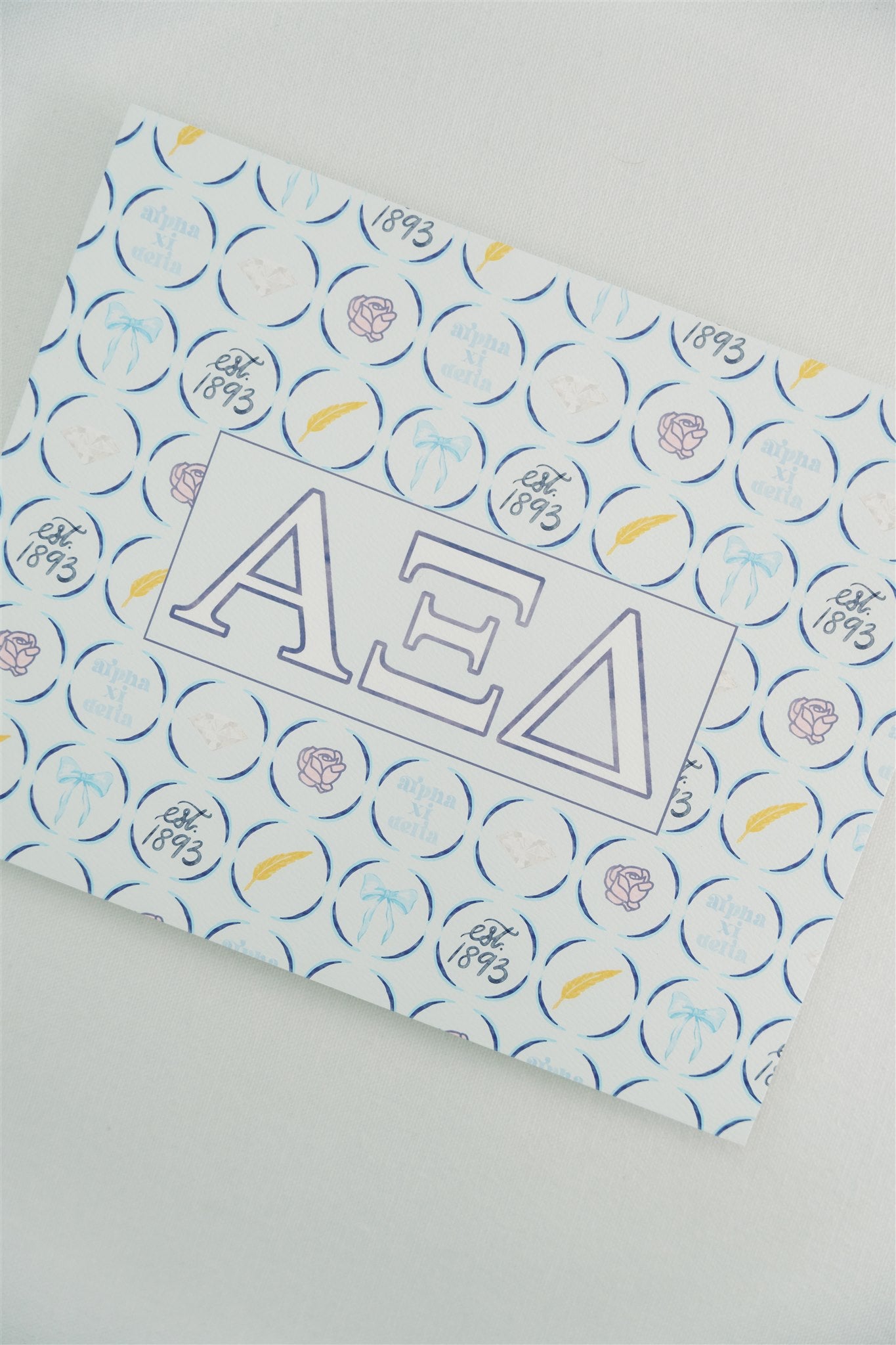 Art print with Alpha Xi Delta Greek letters and pattern on a white background