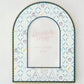 Decorative photo frame with Alpha Xi Delta patterns and Greek letters on a white background