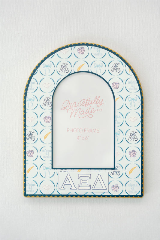 Decorative photo frame with Alpha Xi Delta patterns and Greek letters on a white background