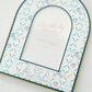 Decorative photo frame with Alpha Xi Delta patterns and Greek letters on a white background