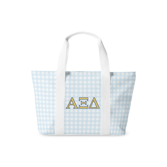 Tote bag with blue gingham pattern and Alpha Xi Delta letters on a white background