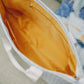 Close-up of the Alpha Xi Delta tote bag with an orange interior liner