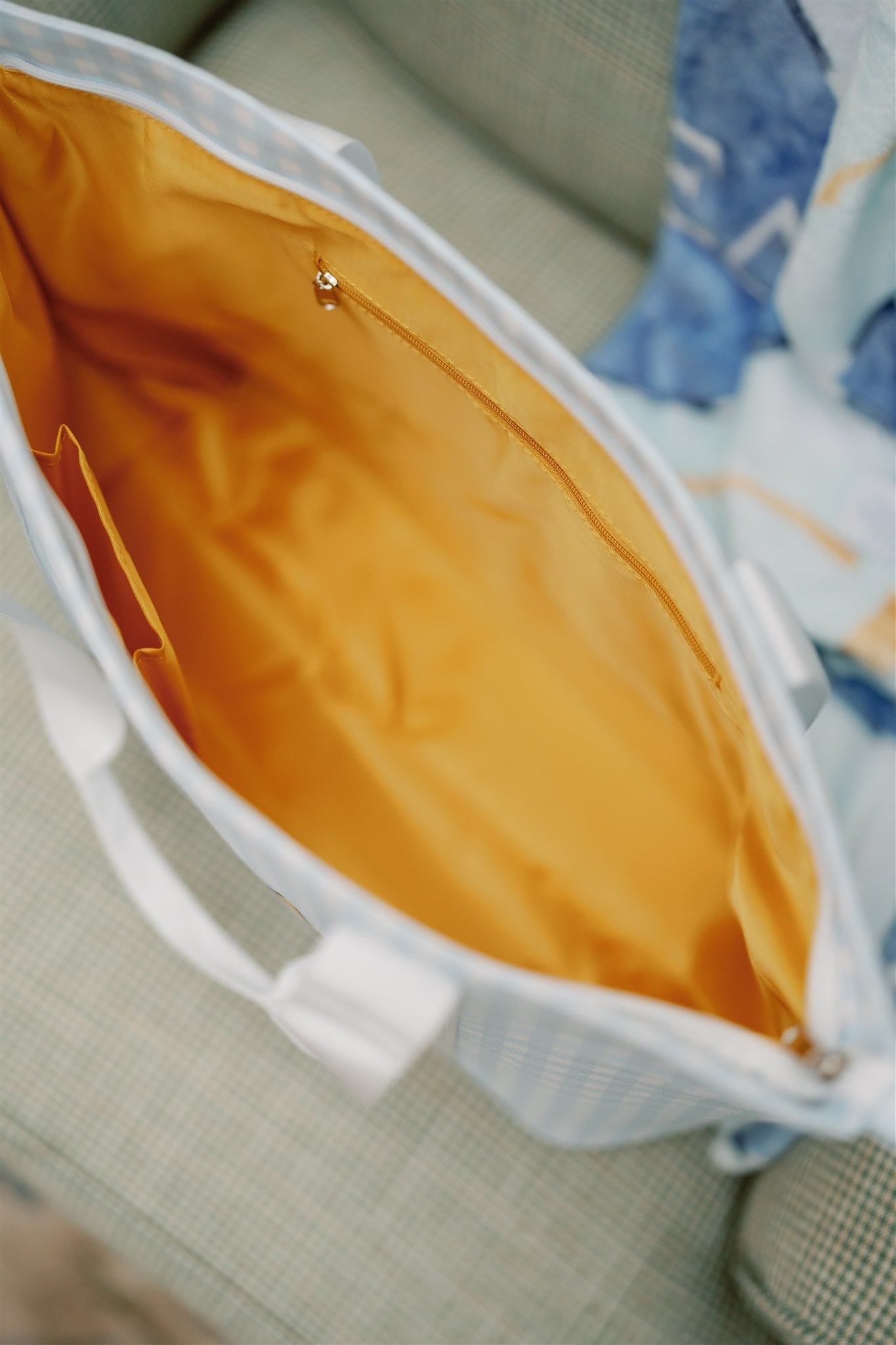 Close-up of the Alpha Xi Delta tote bag with an orange interior liner