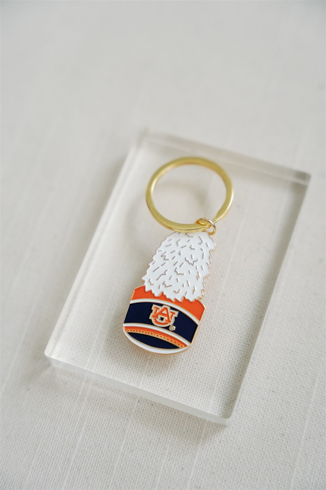 Enamel Keychain of the Auburn University Marching Band Hat with a gold chain.