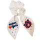 White scrunchie with two ribbons featuring beading of the Auburn logo and "Auburn Tigers."