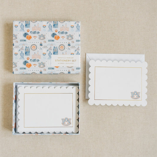 Stationery with scalloped edges, a gold rim, and a watercolor Auburn logo.