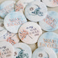 Button with "in my War Eagle era" and a pom pom on it.