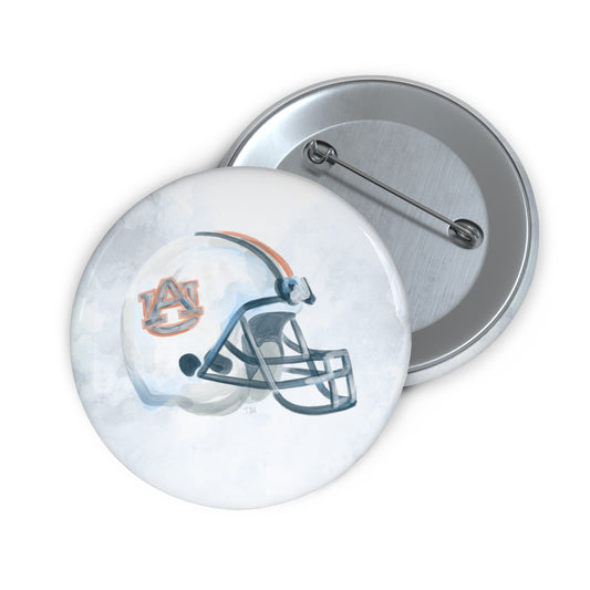 Buttons with a watercolor Auburn University Football helmet on them.