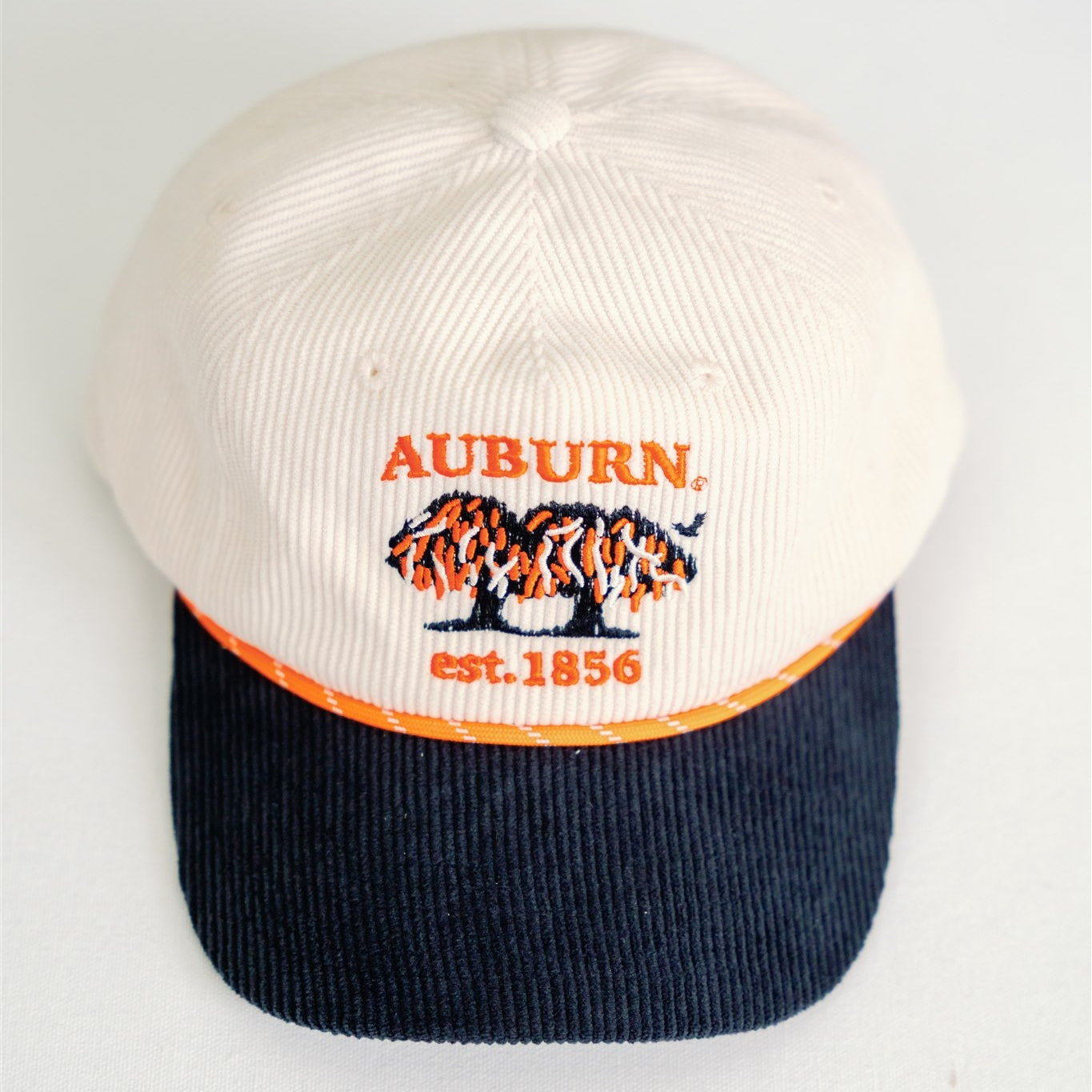 White and navy blue baseball cap with Auburn text on a white background
