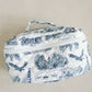 White quilted makeup bag with navy blue Auburn University symbols.