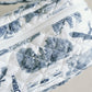 White quilted makeup bag with navy blue Auburn University symbols.