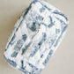 White quilted makeup bag with navy blue Auburn University symbols.