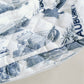 White quilted makeup bag with navy blue Auburn University symbols.