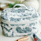 White quilted makeup bag with navy blue Auburn University symbols.