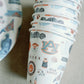 Paper cups with watercolor Auburn University icons and landmarks on them.