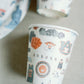 Paper cups with watercolor Auburn University icons and landmarks on them.