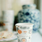 Paper cups with watercolor Auburn University icons and landmarks on them.