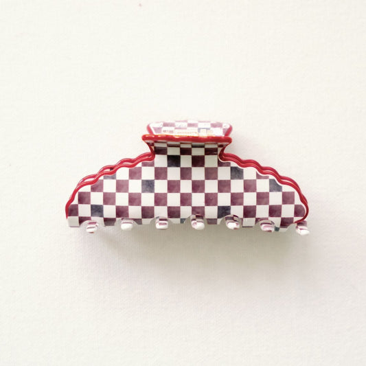 Red and white checkered hair clip on a white background