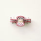 Red and white checkered hair clip on a white background