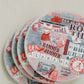 Ceramic coasters featuring a collage of watercolor University of Alabama symbols.