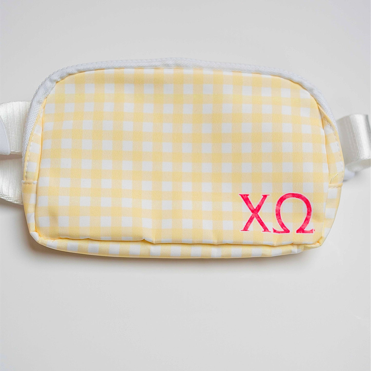 Yellow gingham bag with red Chi Omega Greek letters on a light gray background