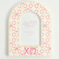 Decorative arch-shaped frame with circular patterns and Chi Omega Greek letters on a light gray background