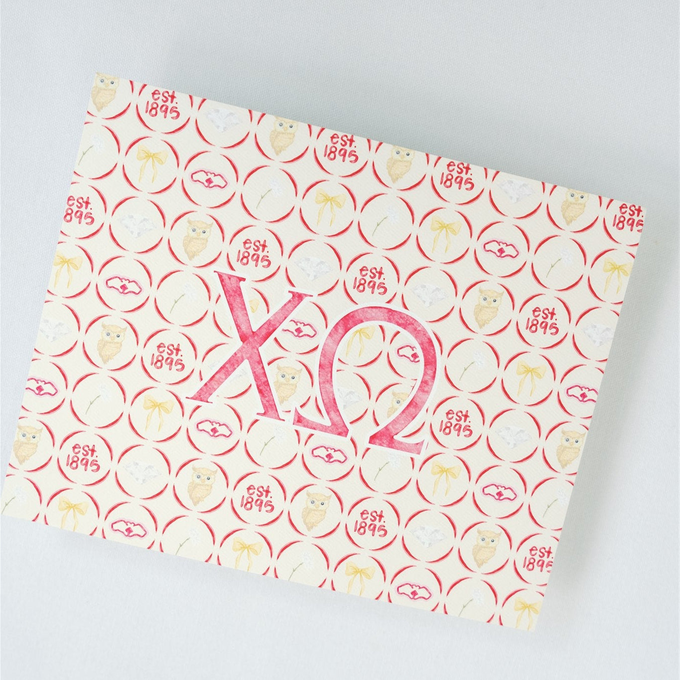 Patterned art print with Chi Omega Greek letters on a light gray background