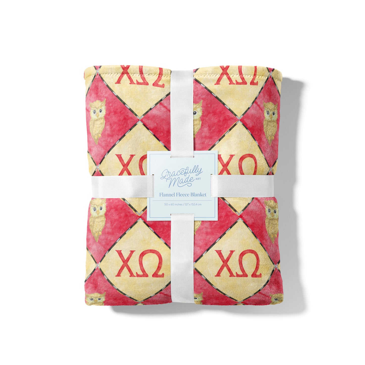 Flannel fleece blanket with owl pattern and 'Chi Omega' letters on a yellow and red background