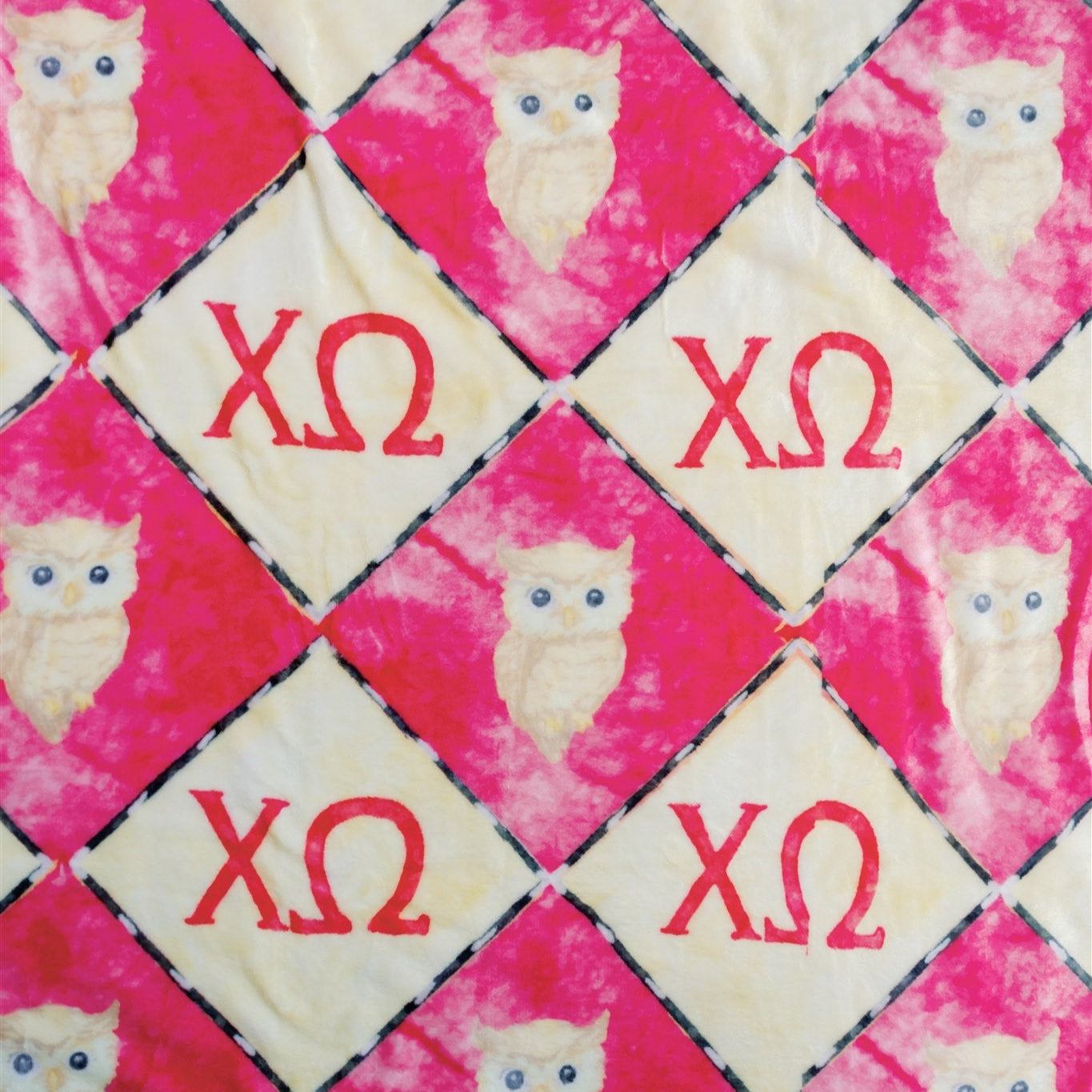 Fabric with owl patterns and 'XO' text on a red and white checkered background