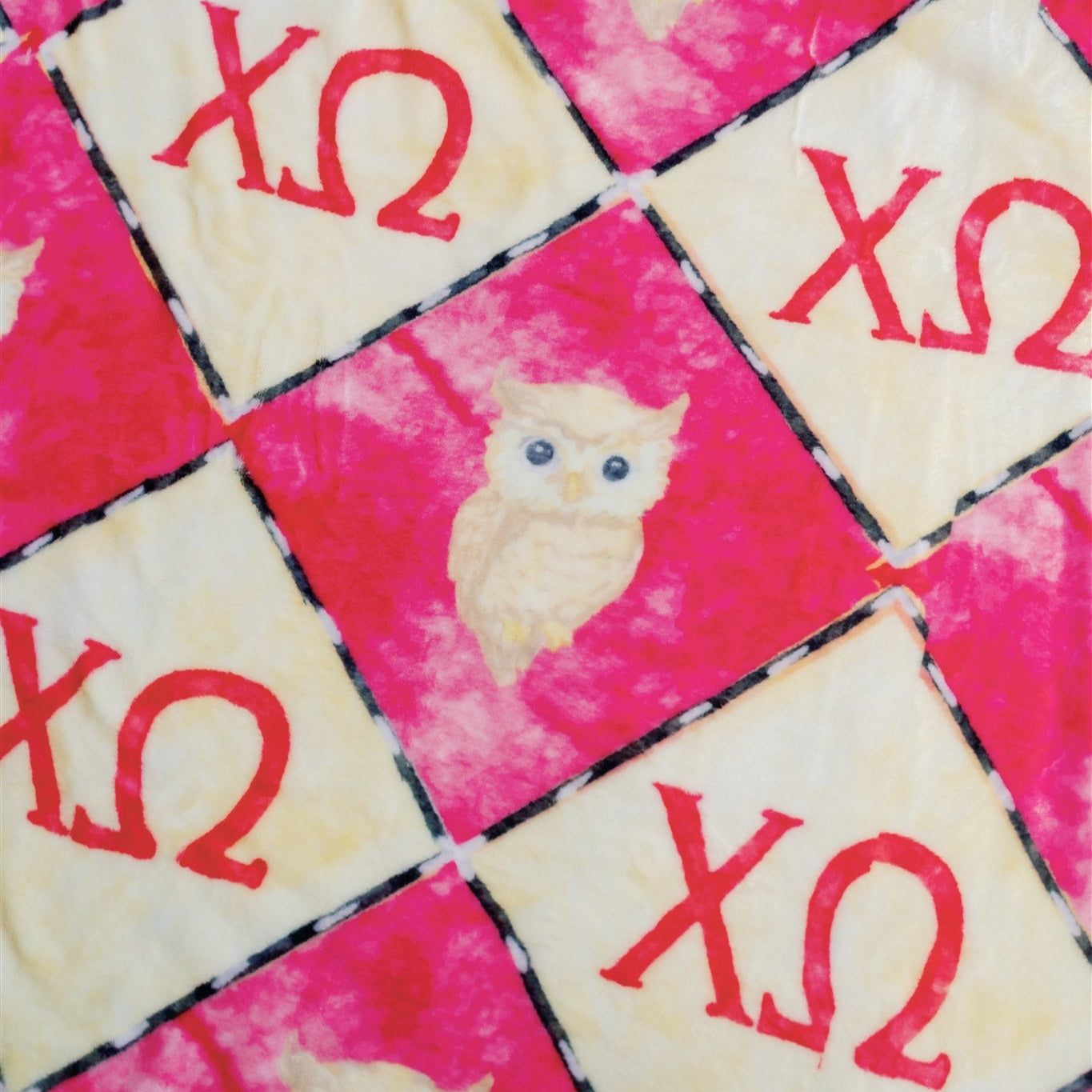 Fabric with owl patterns and 'XO' symbols on a checkered background
