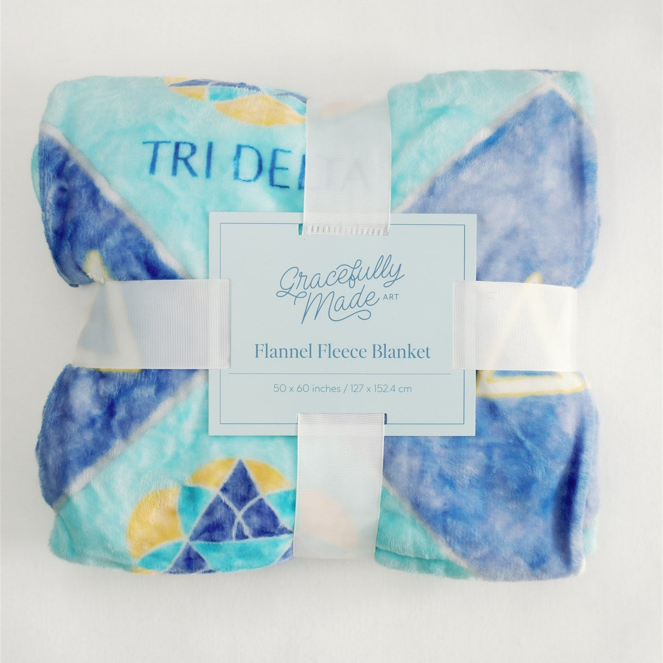 Flannel fleece blanket with Tri Delta symbols on a light and dark blue background