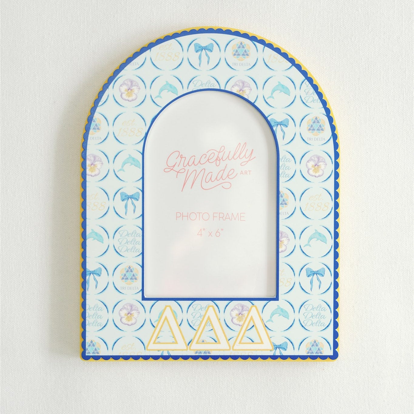 Decorative Tri Delta photo frame with arch design and 'Gracefully Made' text on a light background