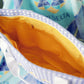 Close-up of the Tri Delta tote bag gold interior liner.