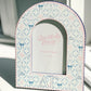 Decorative photo frame with Delta Gamma patterned border and 'Gracefully Made Art' branding.