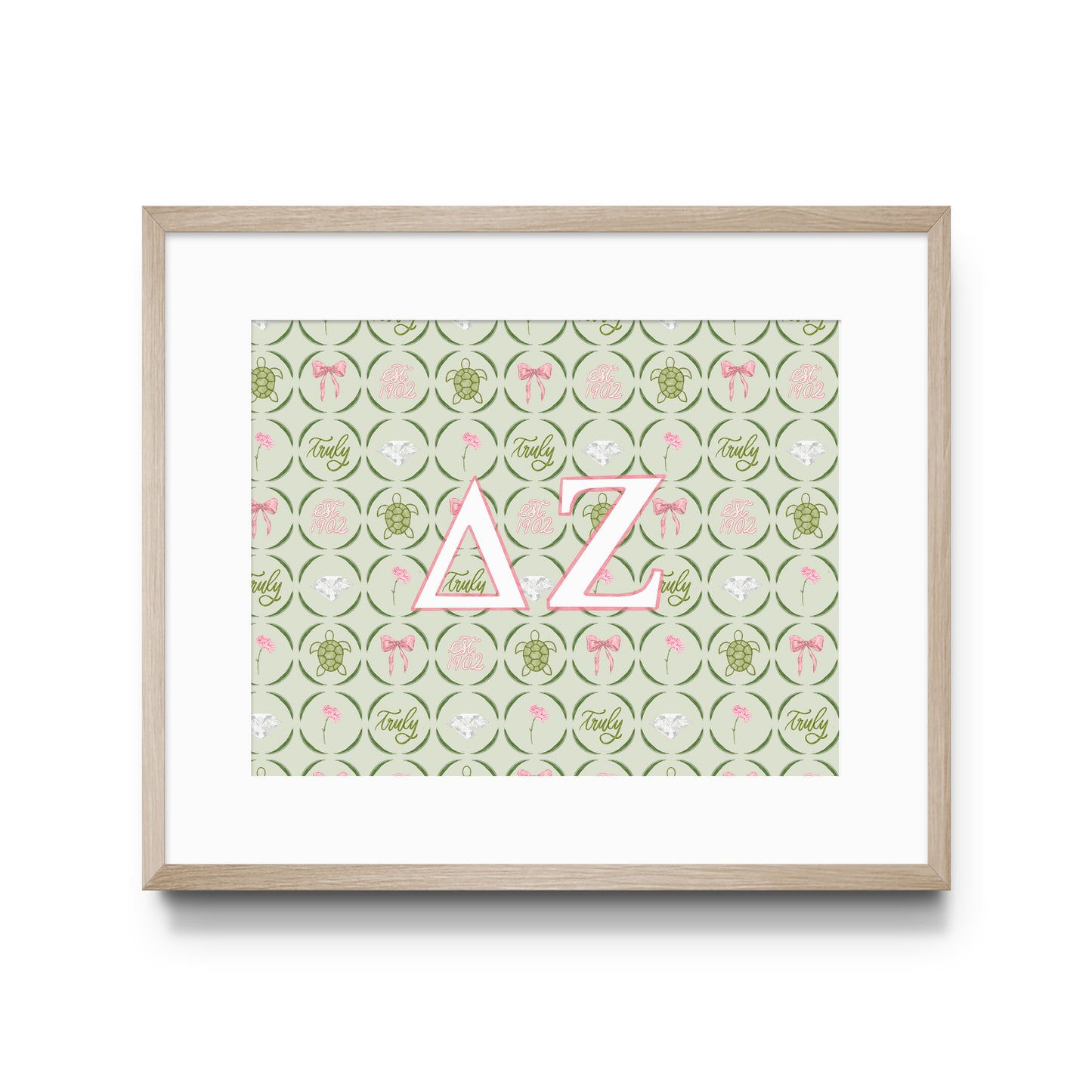 Framed artwork with pink Delta Zeta Greek letters on a patterned background