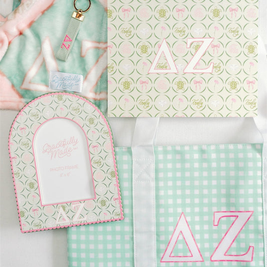 Collection of Delta Zeta items with lettering and patterns on a light green background.
