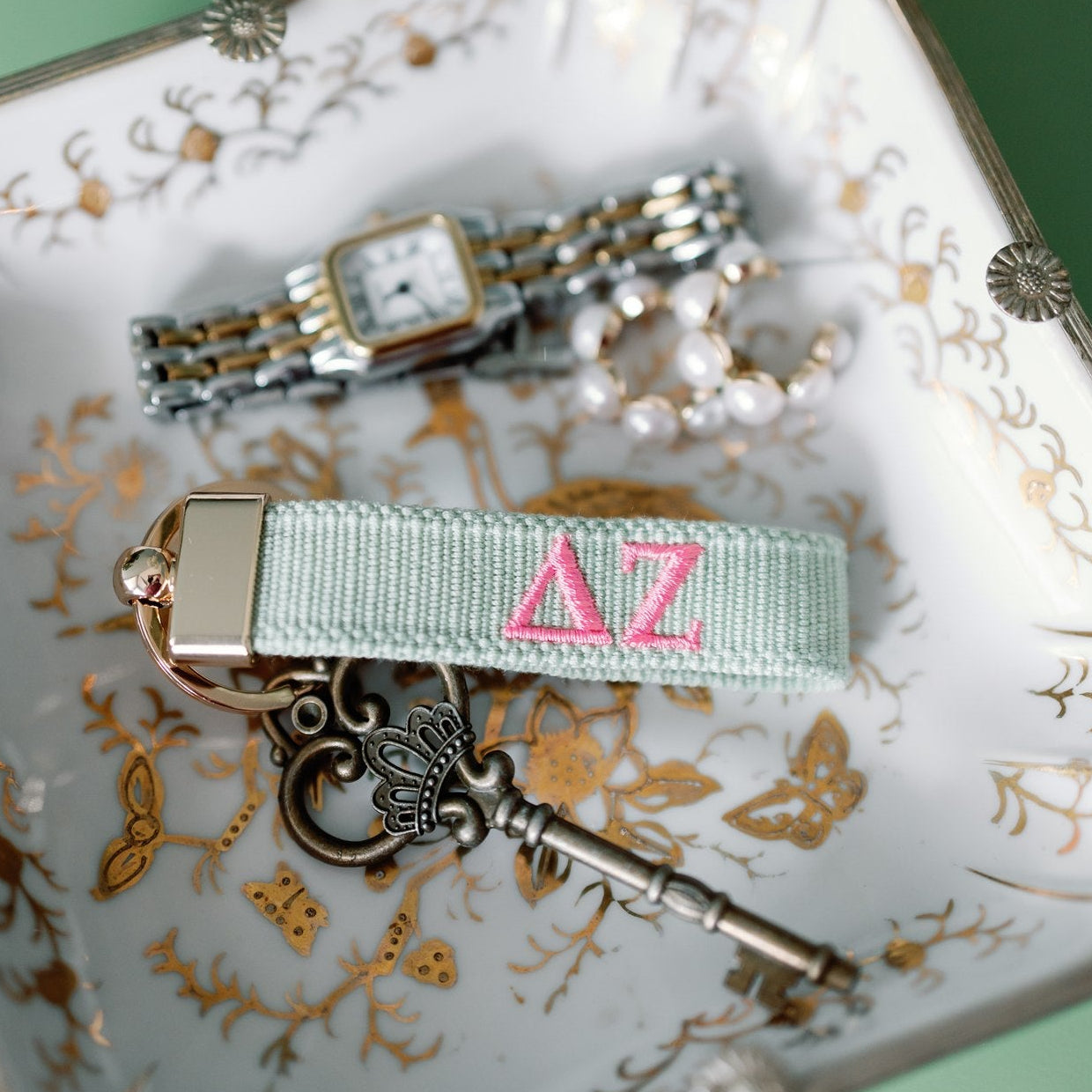Keychain with 'Delta Zeta' Greek letters on a decorative plate with jewelry