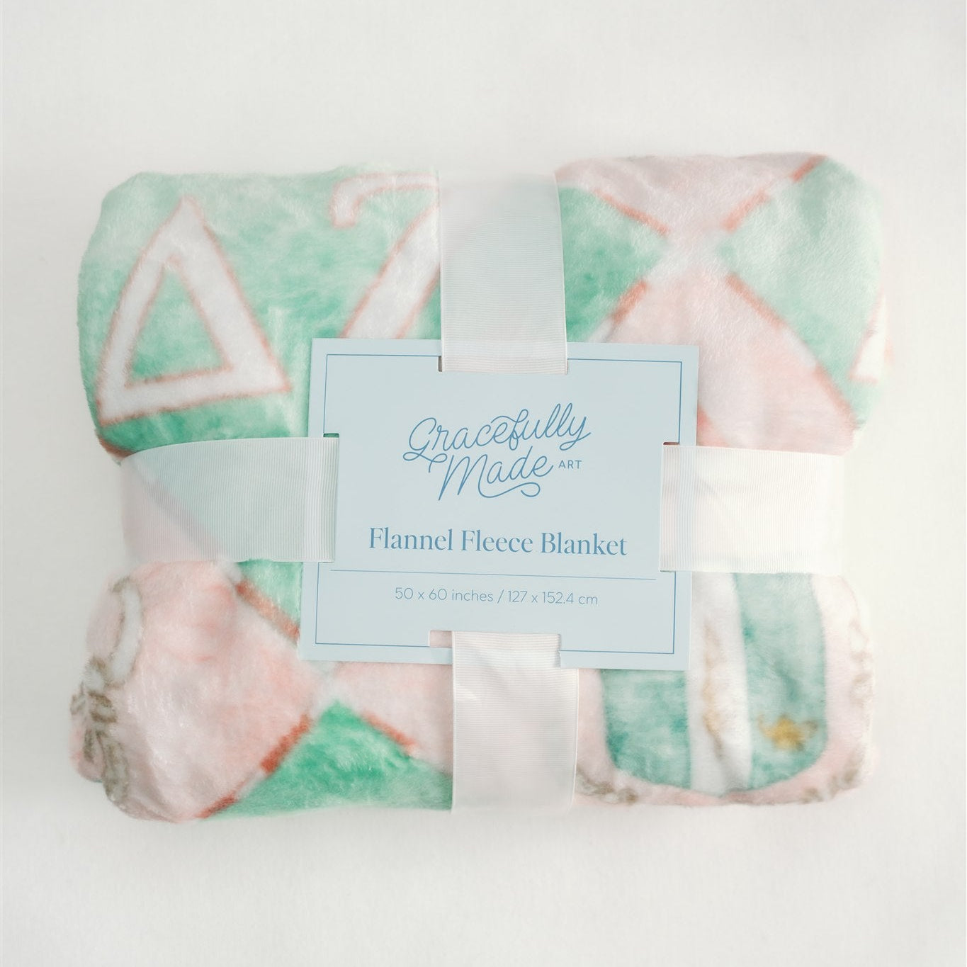 Flannel fleece blanket with checkered pattern and Delta Zeta Greek letters