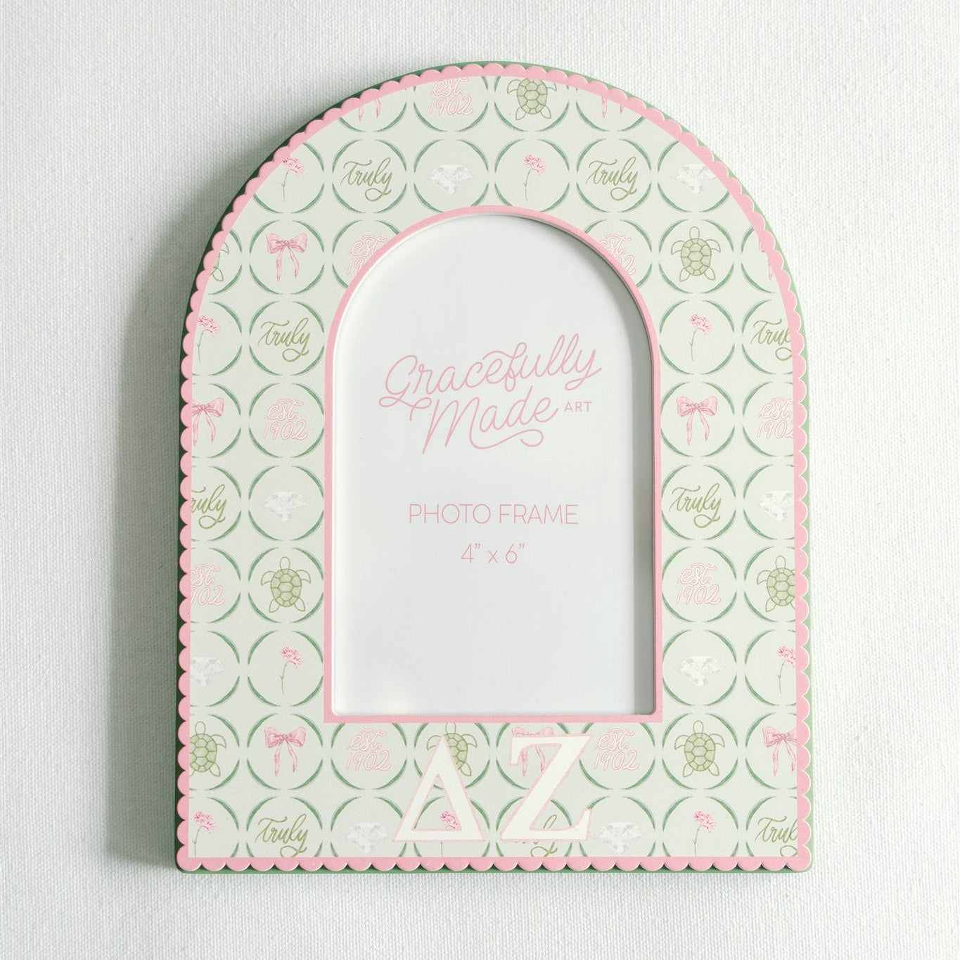 Decorative photo frame with Delta Zeta pattern and greek letters on a white background.