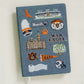 Hardcover navy blue notebook with various Auburn University icons embroidered on the front.